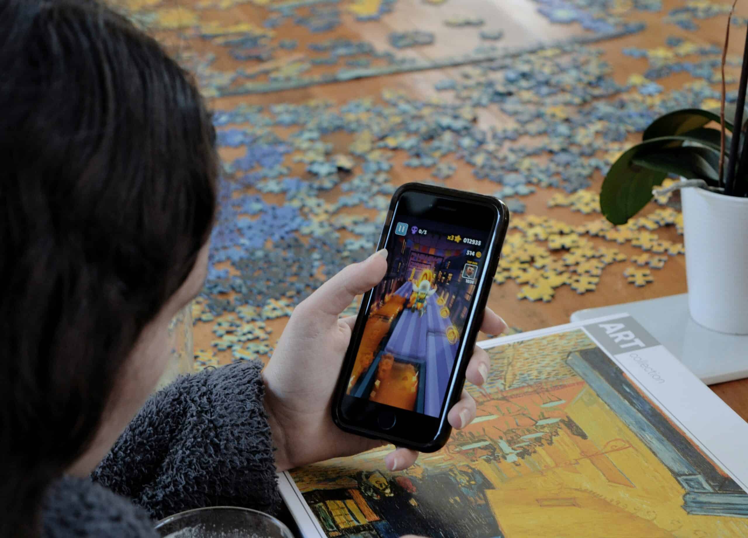 Person holding phone playing a game on the phone