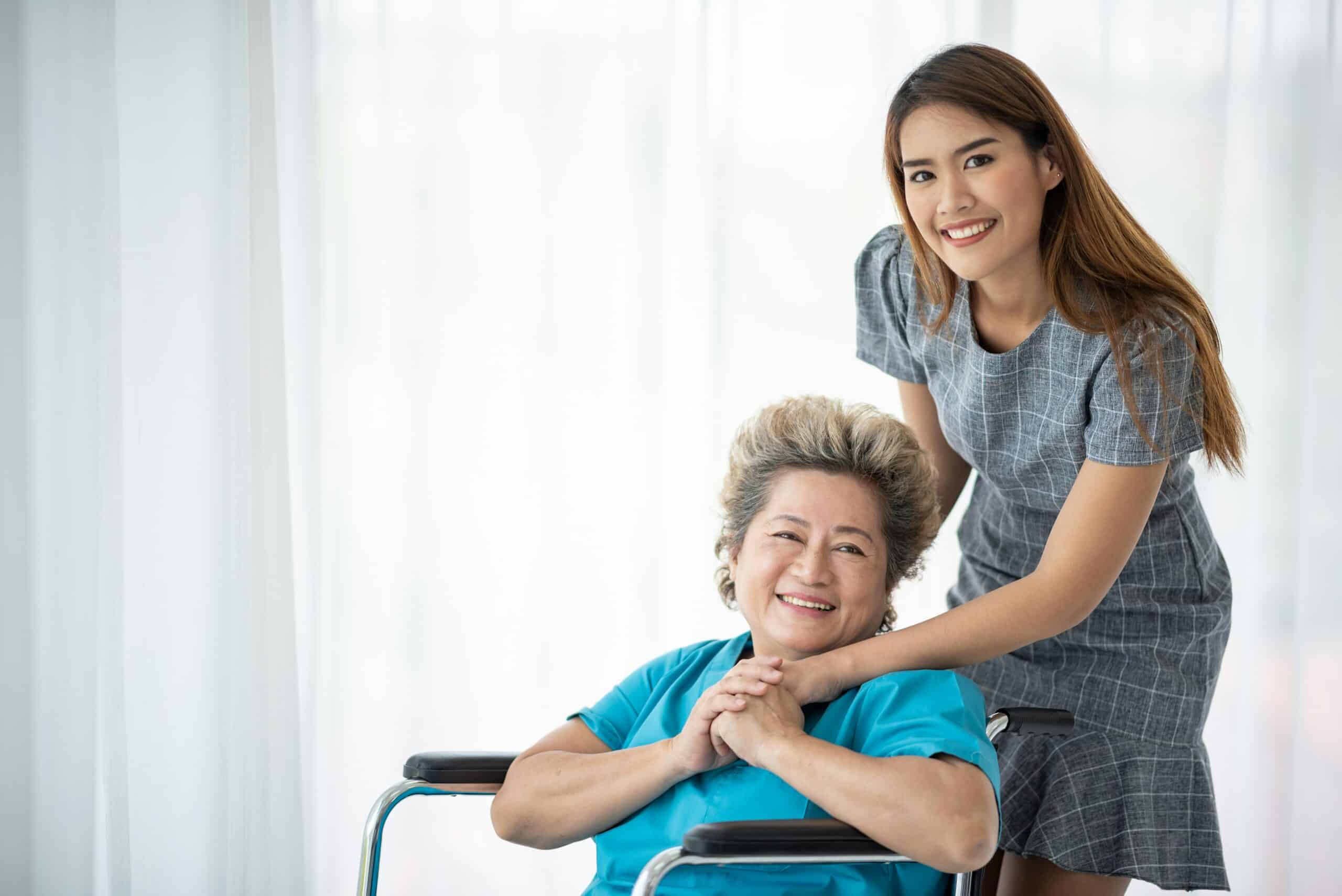 Woman pushing older women in wheelchair