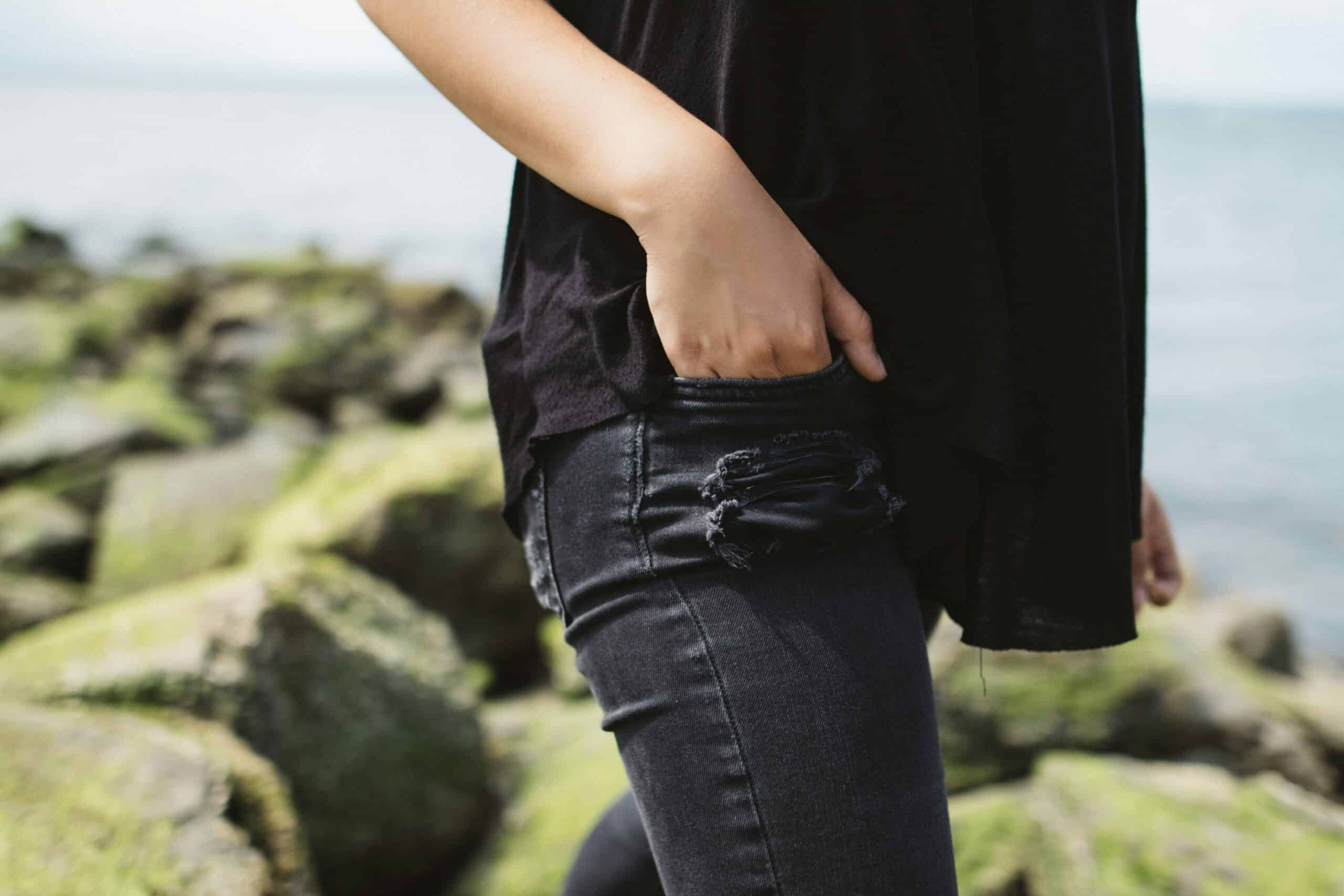 Person putting their hand in their pocket