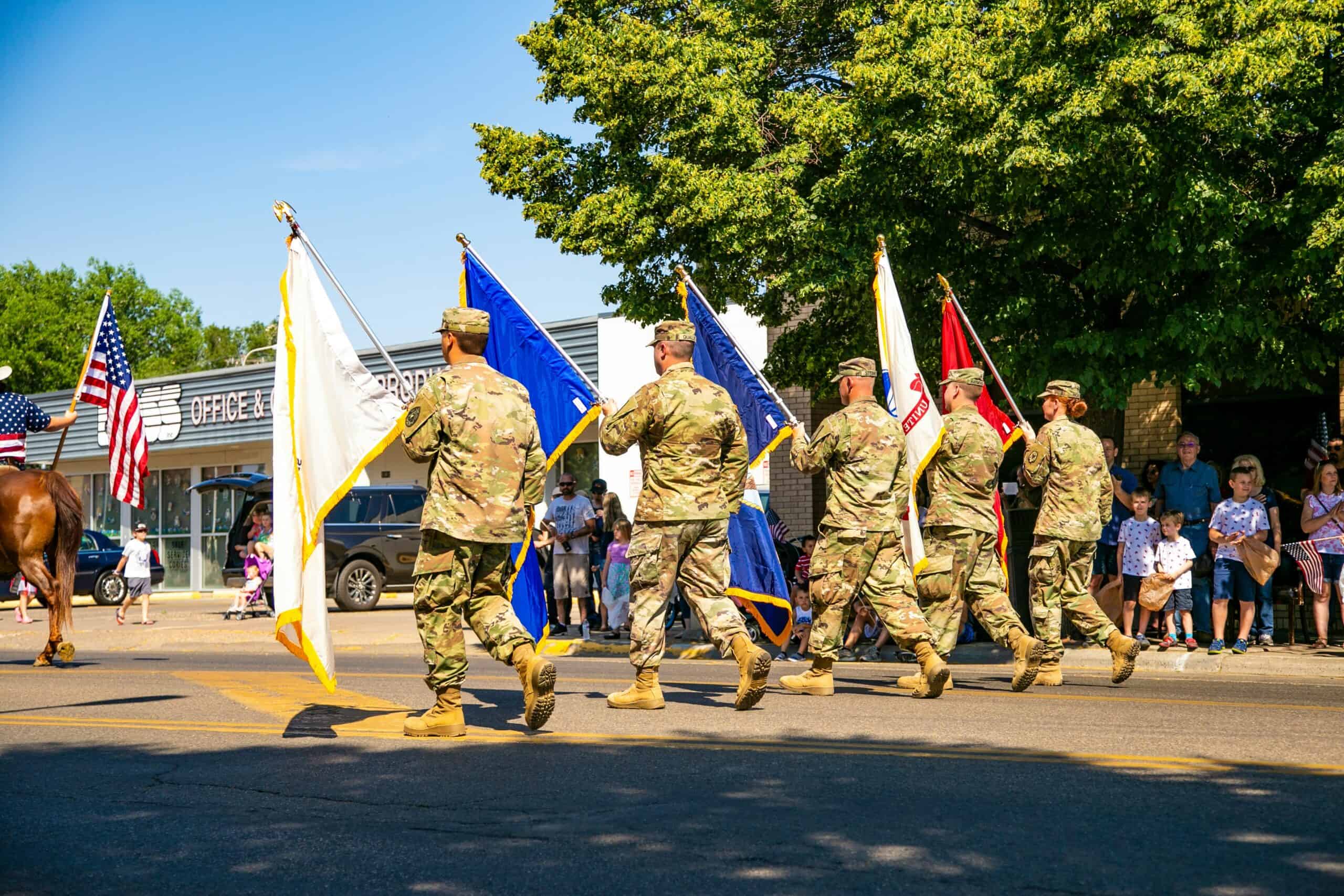 Soldiers holding U.S. military branch flags in parade