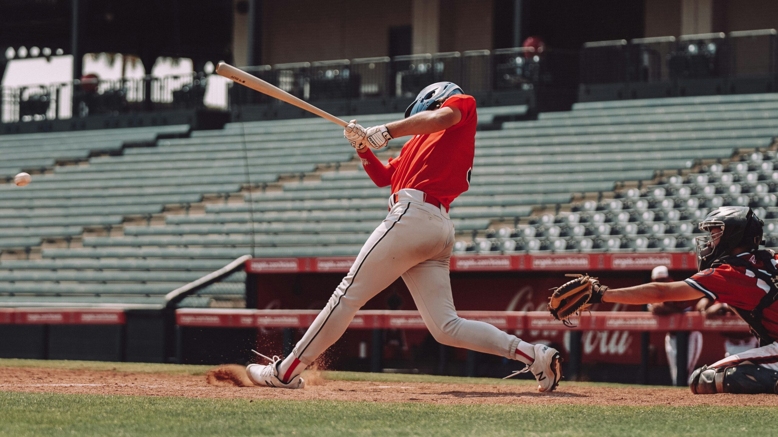 Baseball batter swinging at incoming pitch in baseball game