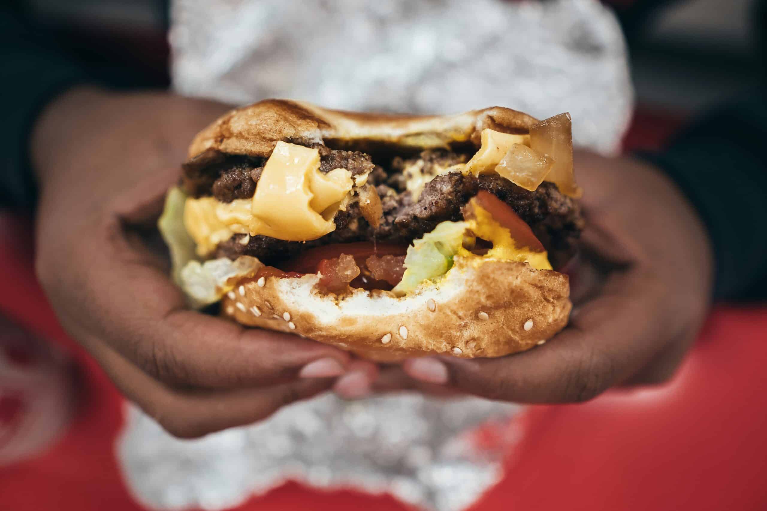 Hands holding Five guys burger